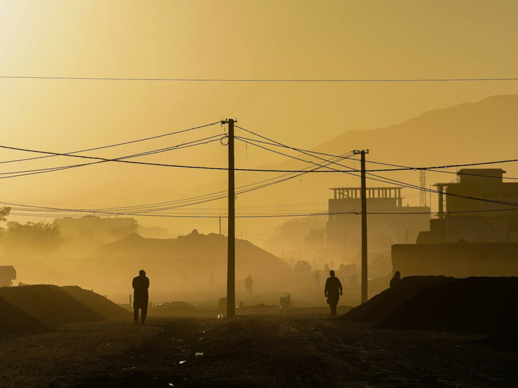 The silhouettes of people on the street in the Afghan capital Kabul as the sun rises.